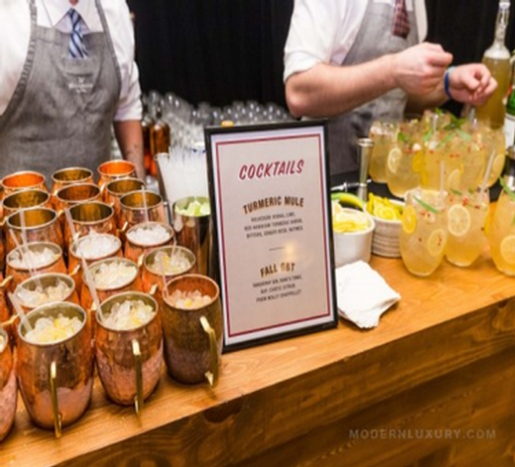 Colorful cocktails and drinks at the 90 Plus Wine Club event, featuring a cocktail menu and fresh ingredients.