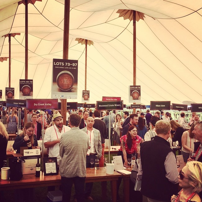 Crowd at Sonoma Barrel Auction 2018 with wine lots and vendors under large tent.