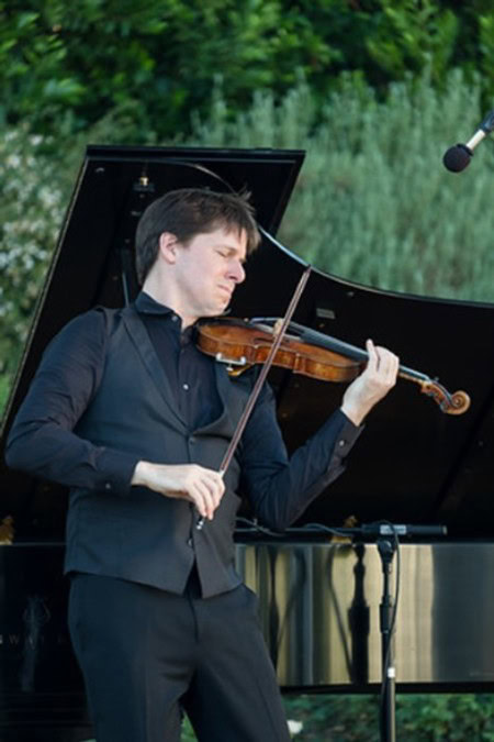 Violinist performing outdoors at 2018 Festival Napa Valley with a grand piano in the background.