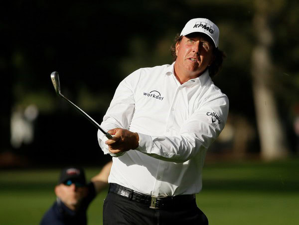 Golf player swinging club during PGA Safeway Open in Napa, with focus on technique and concentration.