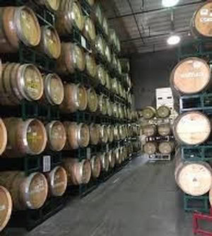 Wine barrels stored in a cellar at 90 Plus Wine Club in Napa Valley.